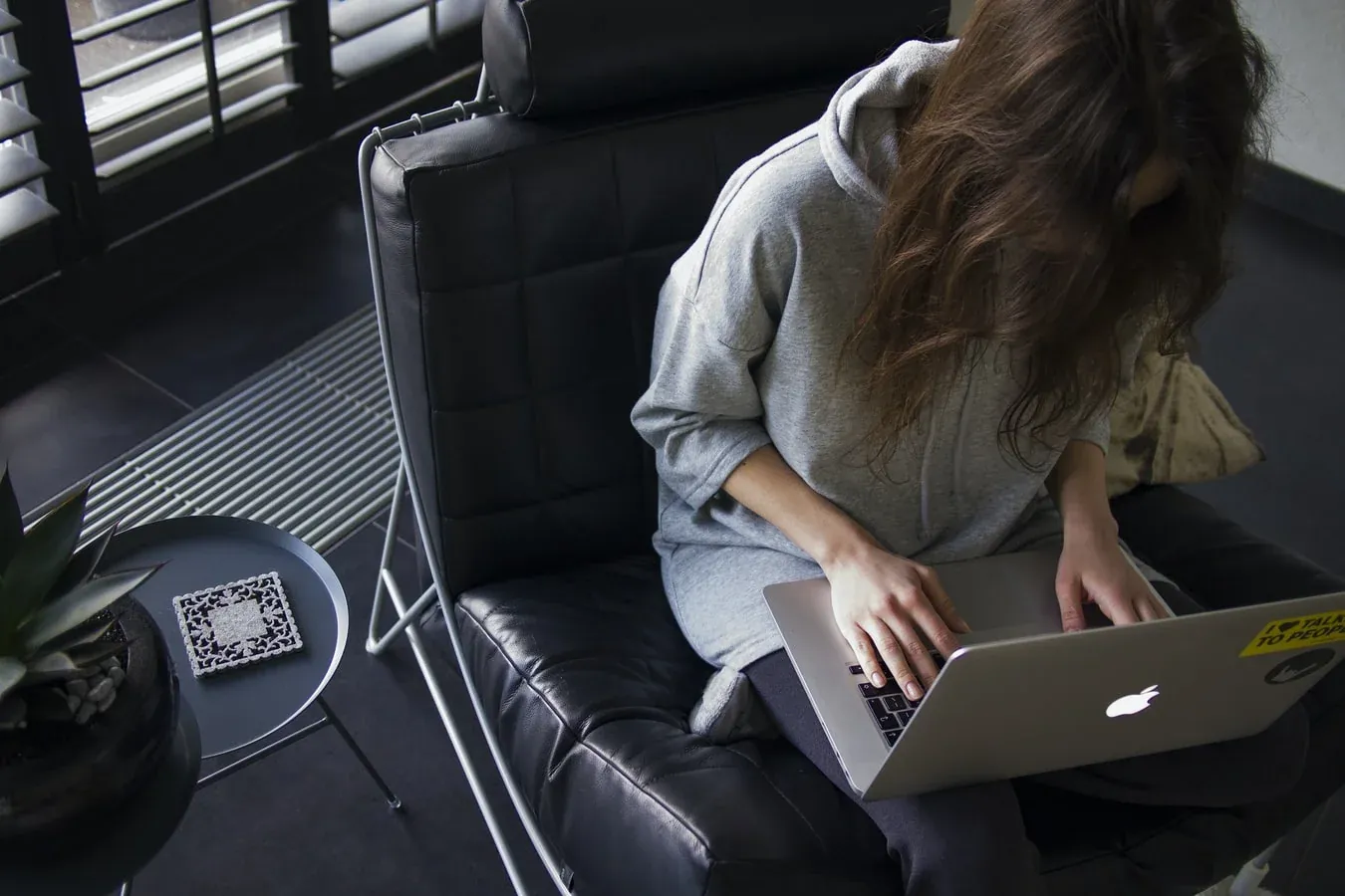 Remote worker typing on a laptop, enjoying a flexible and modern work environment