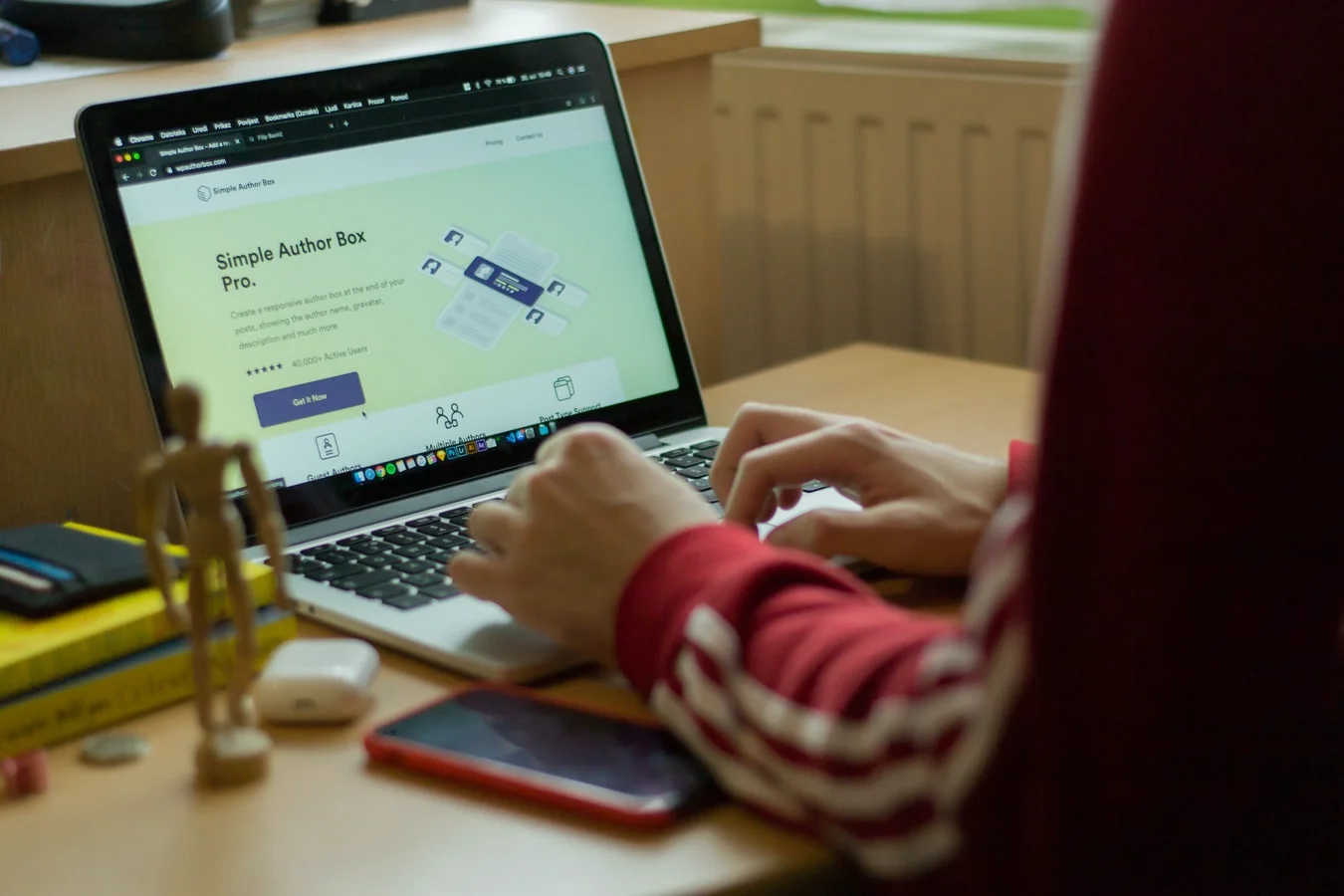 Person writing engaging biography on laptop to improve career profile
