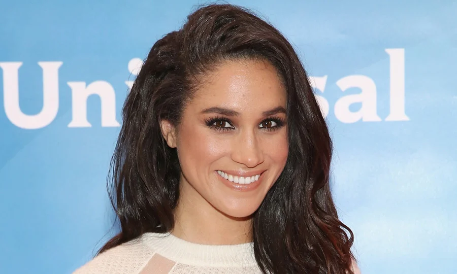 Meghan Markle, Duchess of Sussex, at a public royal engagement smiling gracefully