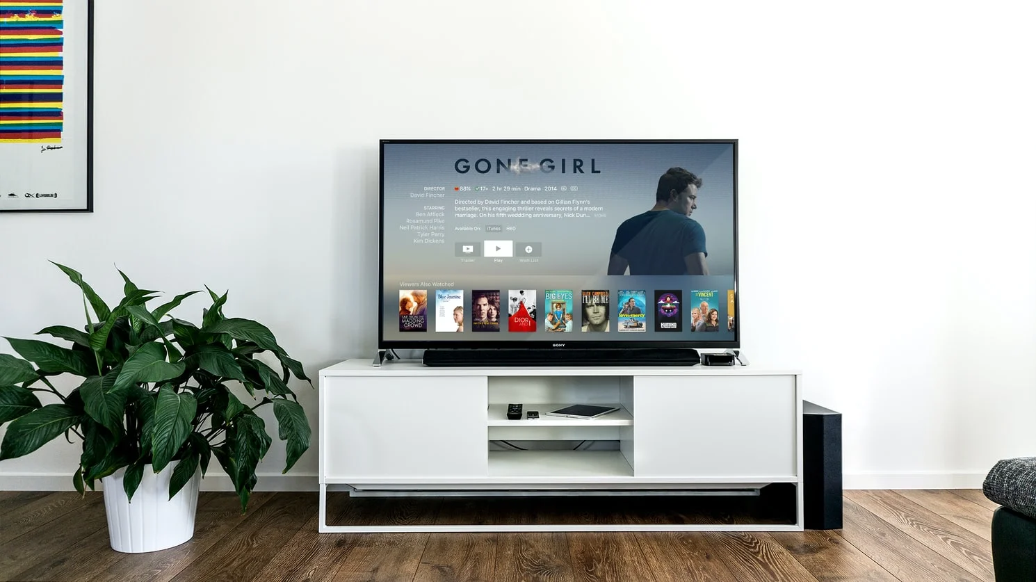 A person enjoying a classic Halloween movie on Apple TV+ with a bowl of popcorn