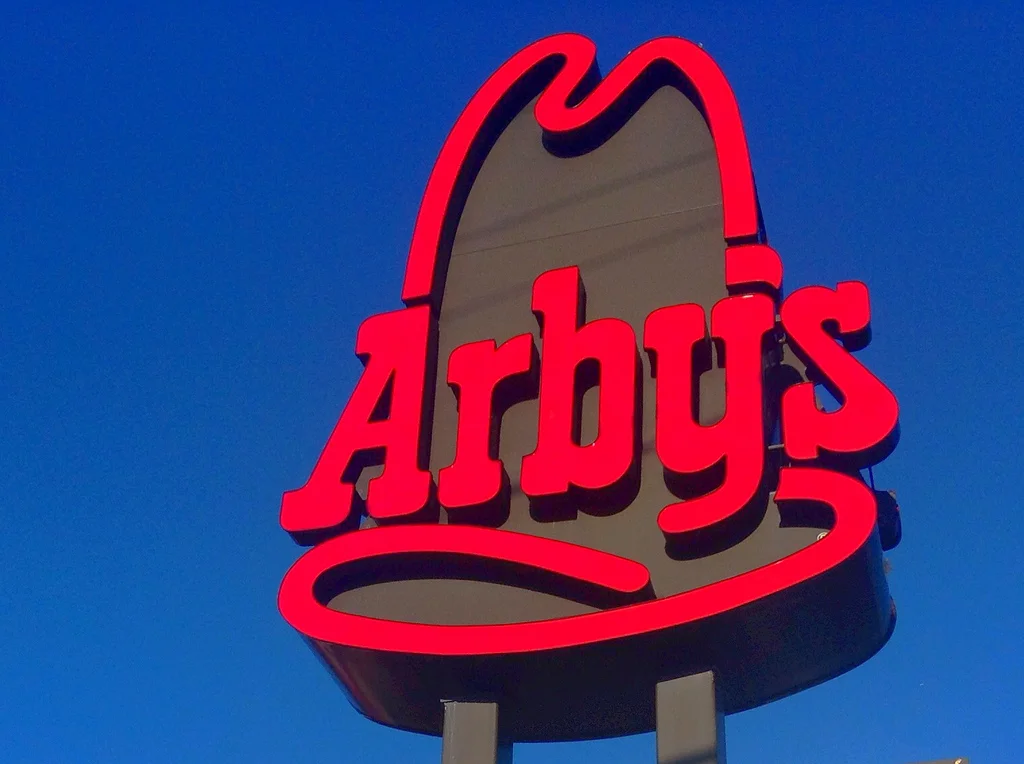 A smiling bag of Arby's food next to its stoic, unamused counterpart