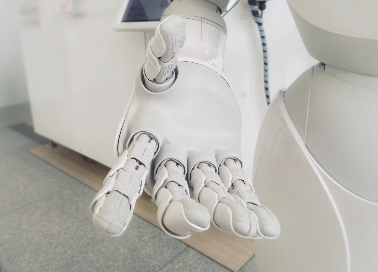 A robotic hand pointing to a digital display showing marketing analytics data