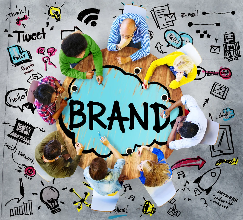 Branding toolkit on a wooden desk, analyzing brand identity and visual messaging strategies