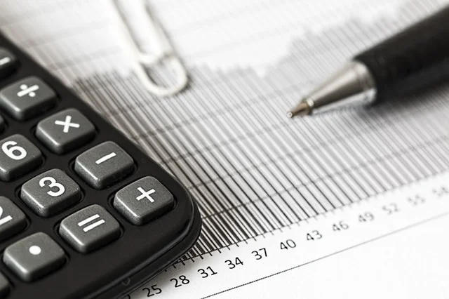 Person analyzes financial data and charts, seeking the best investment advice