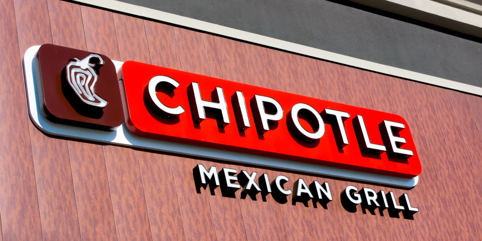 Sick person clutching stomach, symbolizing Chipotle's food safety issues