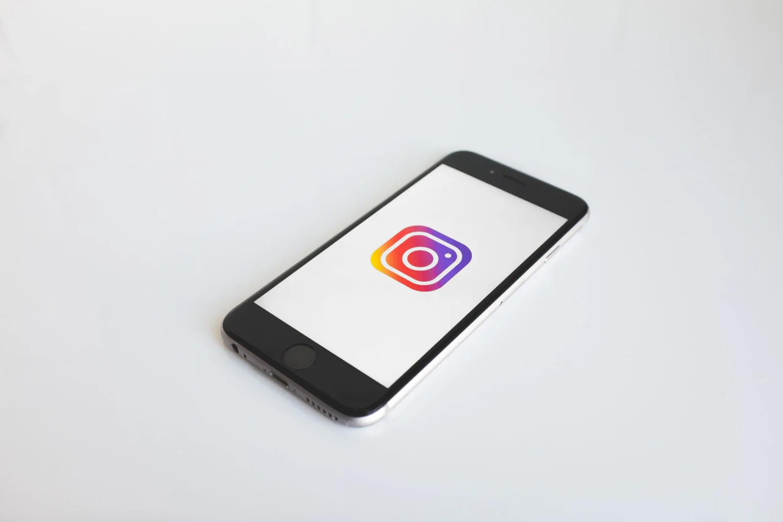 Smartphone displaying Instagram feed with notification bubbles and blurred user profiles
