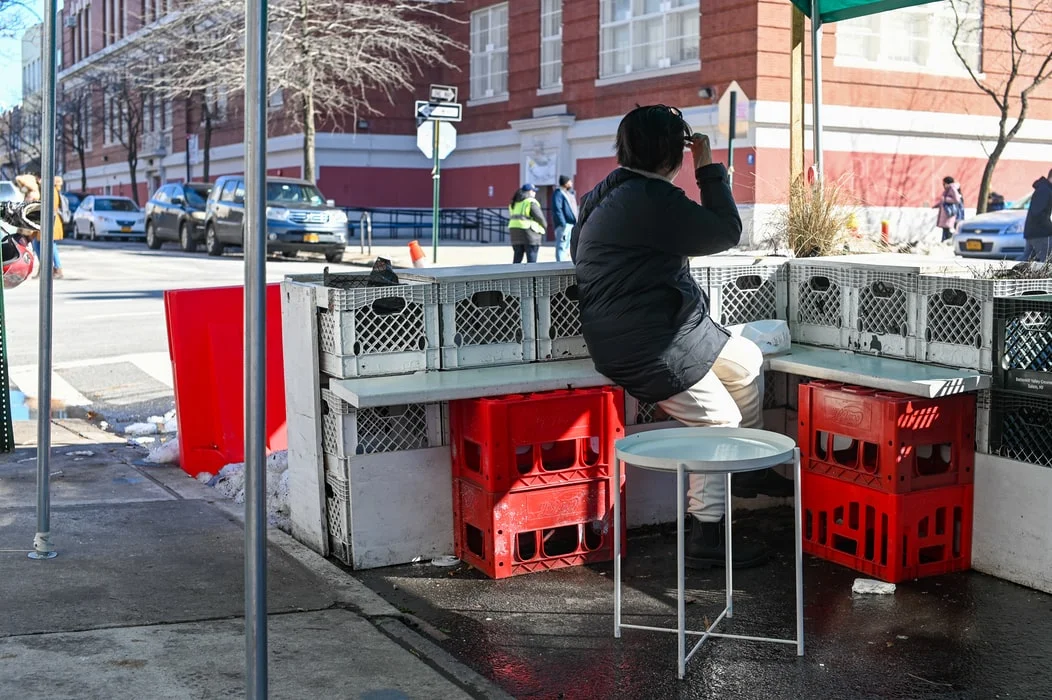 Stack of milk crates collapsing, illustrating the viral social media challenge danger
