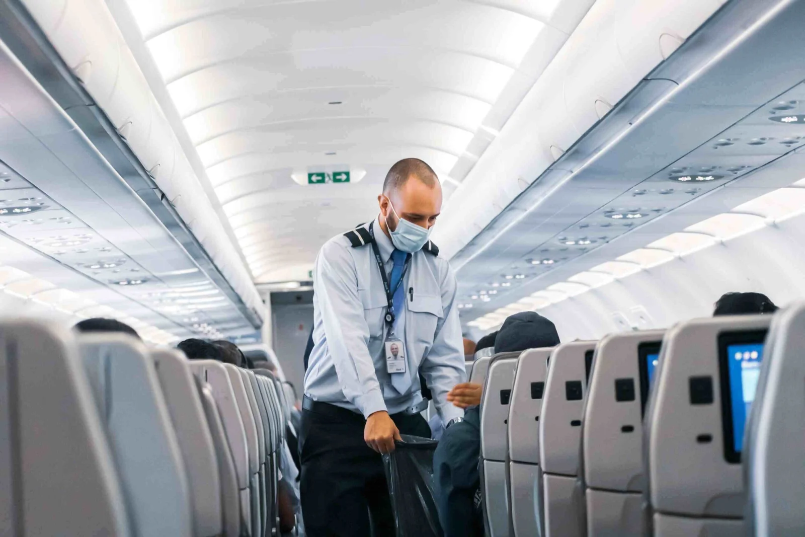 Airline employee assisting a passenger at a check-in counter