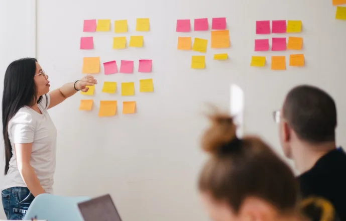 A person reviewing an e-commerce marketing plan on a laptop and paper