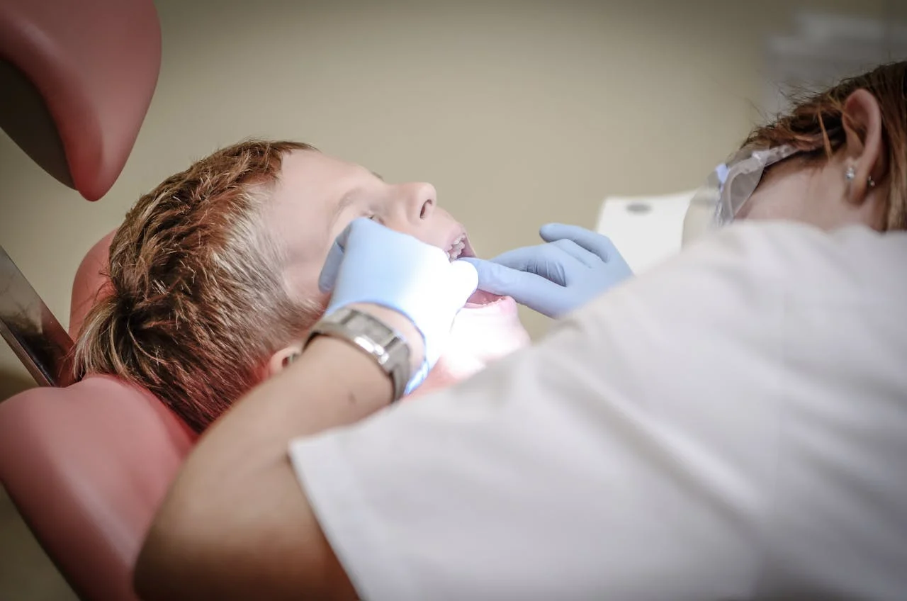 Dentist consults with smiling patient, illustrating effective dental marketing strategies