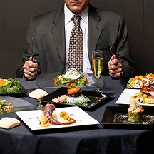 Restaurant owner using a tablet to analyze digital marketing data and sales trends