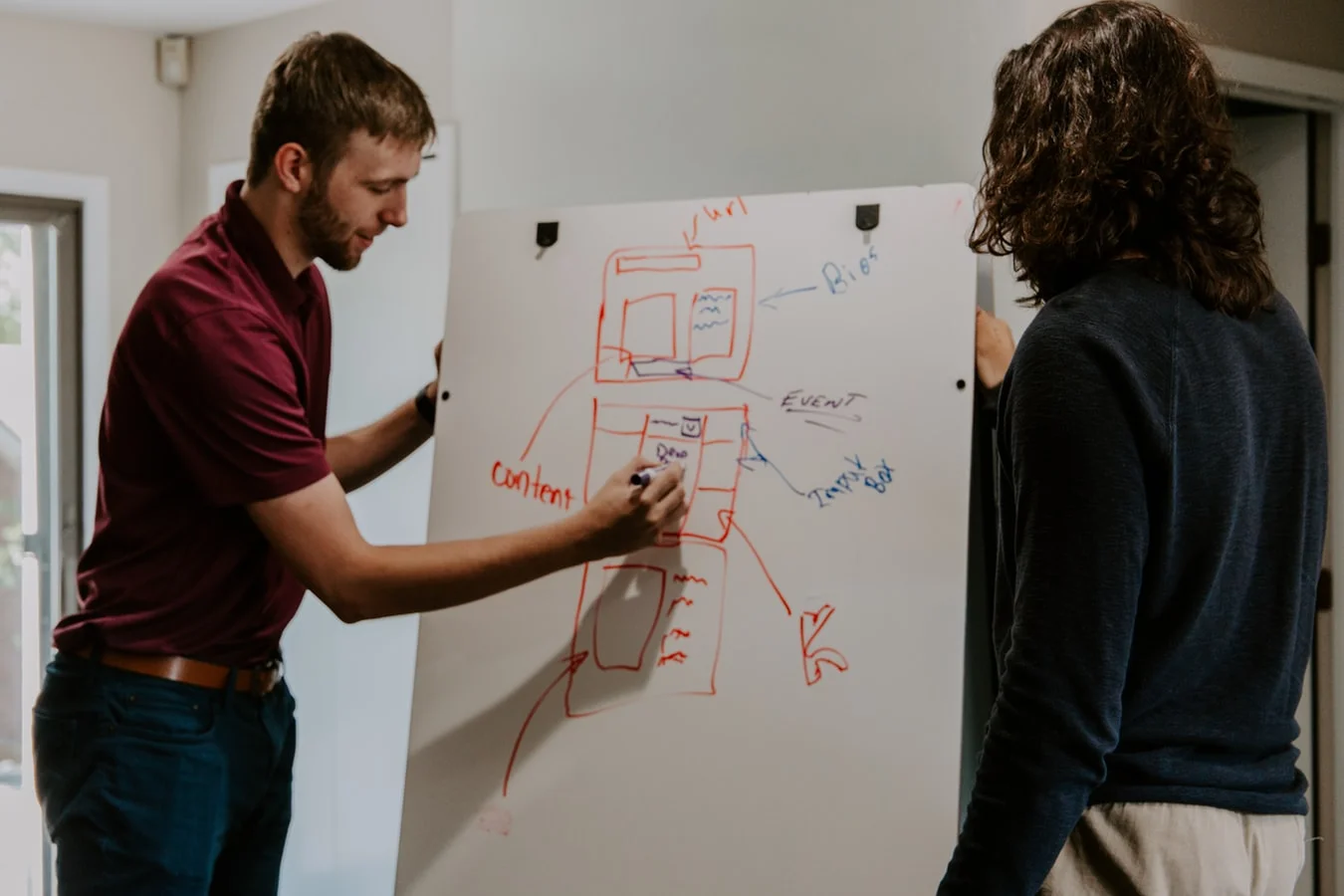 A businessperson studies data on a transparent screen, optimizing a digital strategy