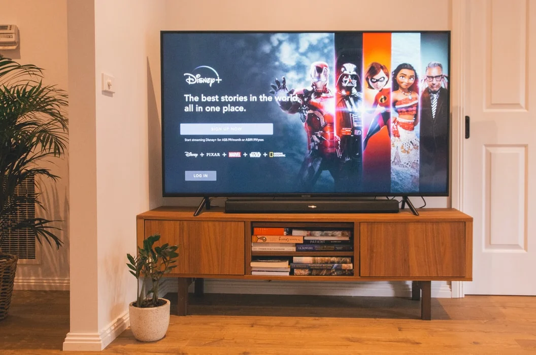 A person watching TV, holding a remote, optimizing their promotional strategy