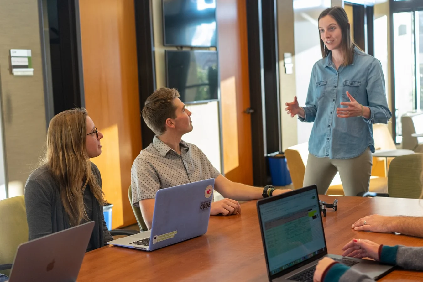 A diverse team celebrates success, illustrating the power of employee advocacy for ROI