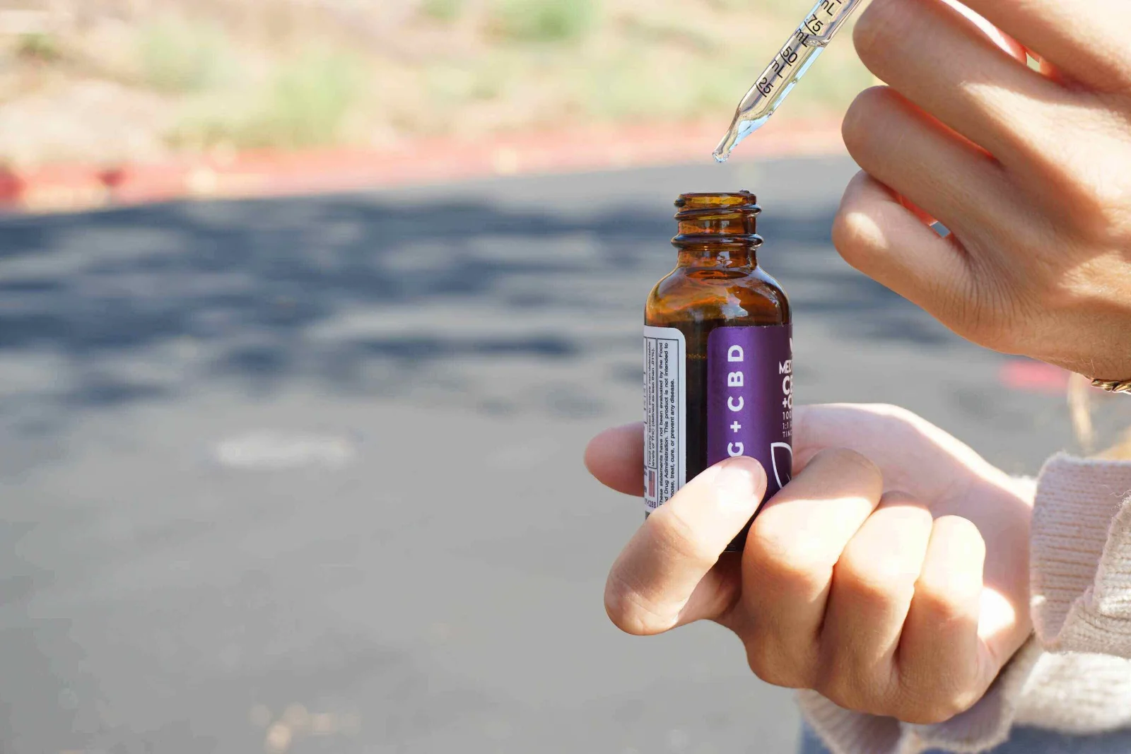 Happy woman holding CBD product, reflecting customer loyalty and repeat purchases
