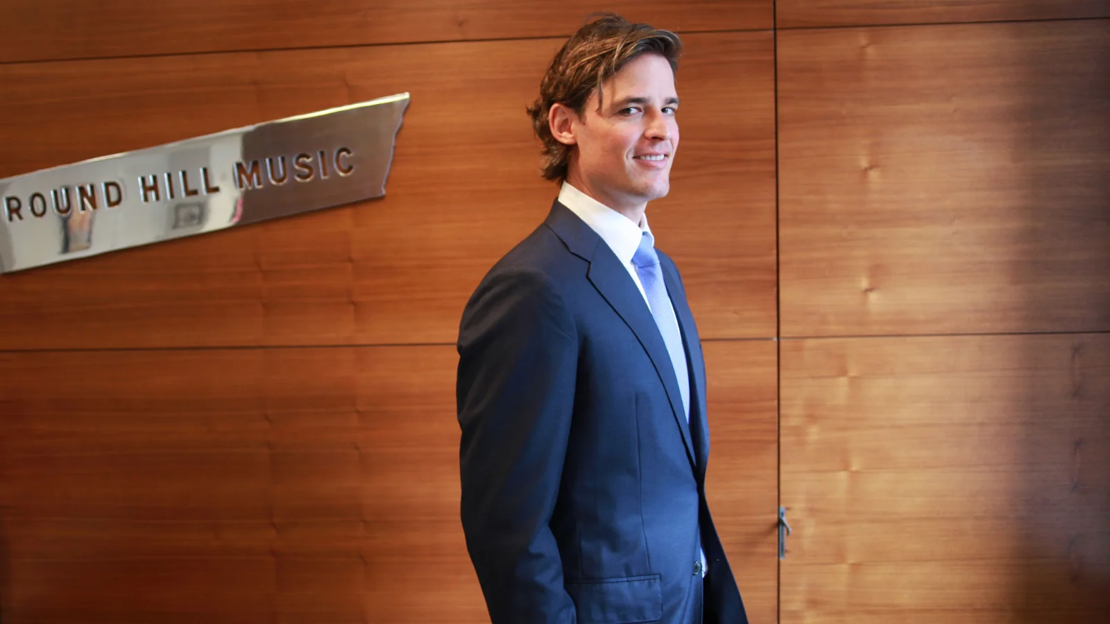 Joshua Gruss, Round Hill Music CEO, in an executive business portrait in an office