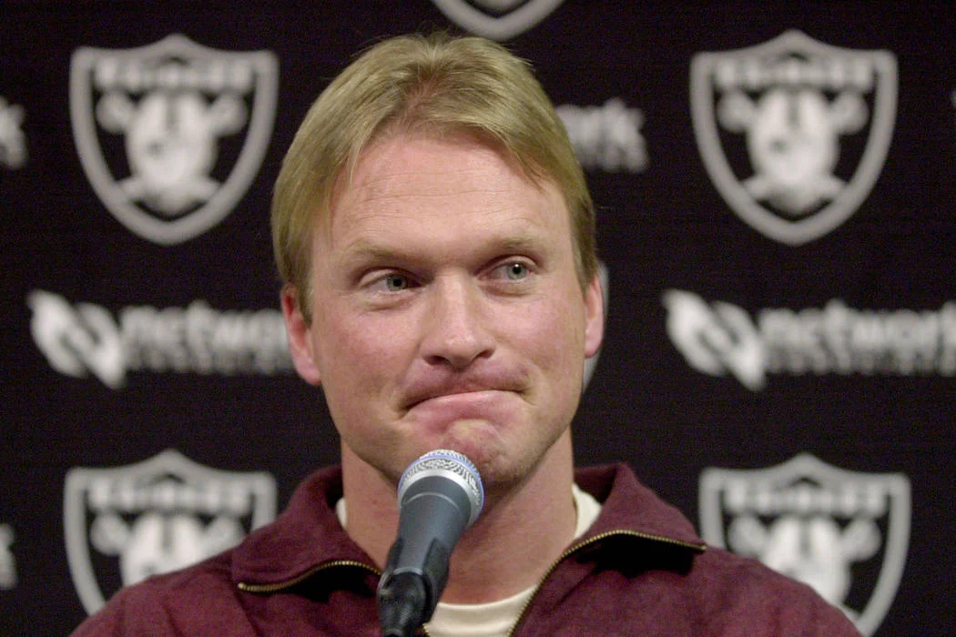 Jon Gruden in a football stadium, considering a return to coaching