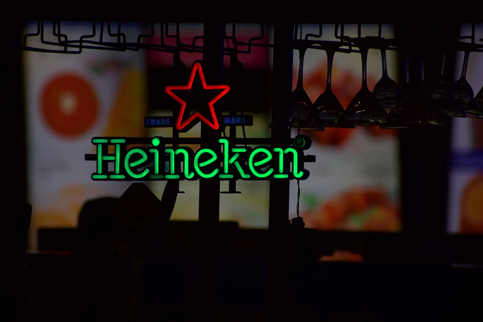 Heineken bottle opener revealing a refreshing, foamy beer in a glass