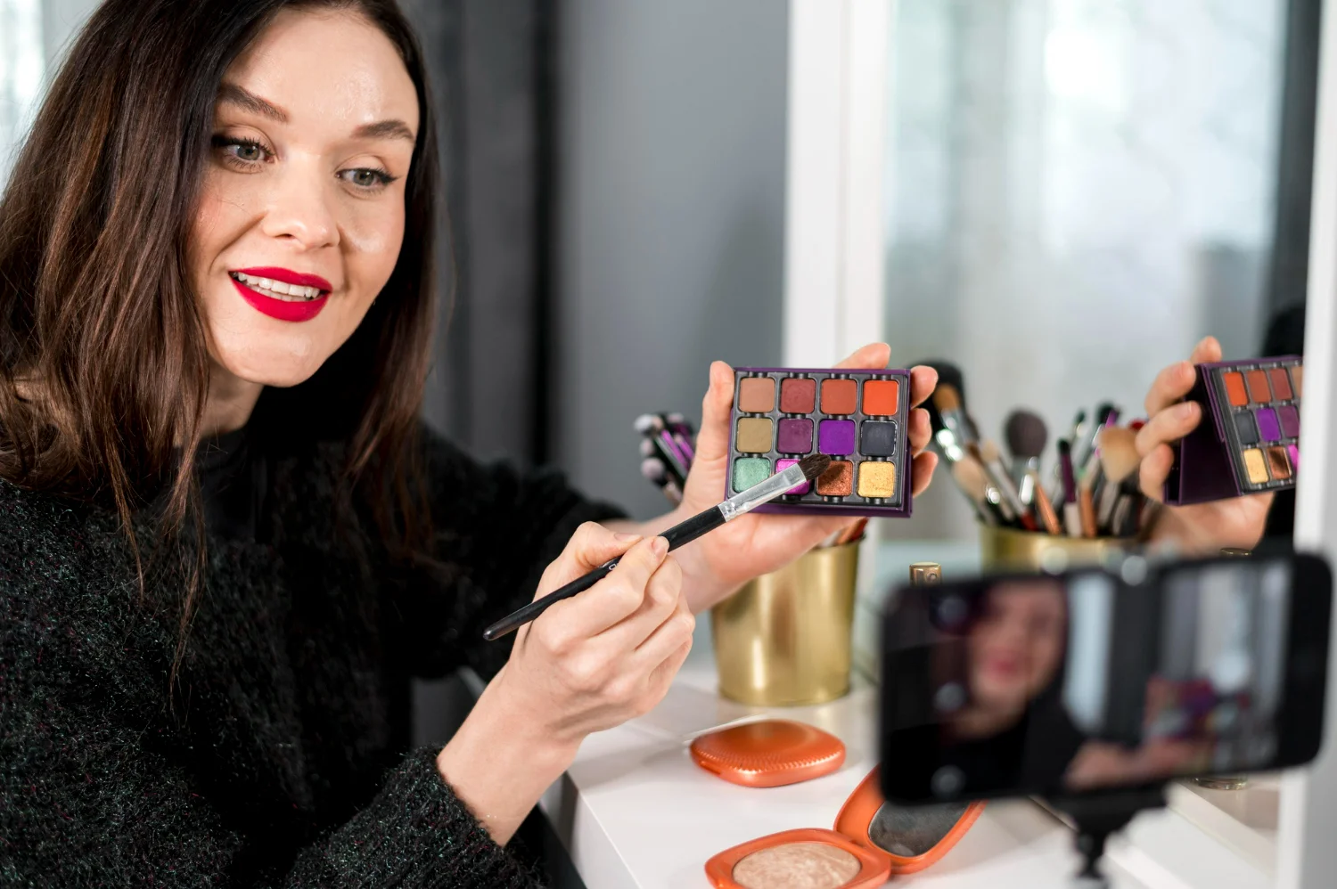 A poised woman applies makeup, illustrating how marketing elevates beauty brands