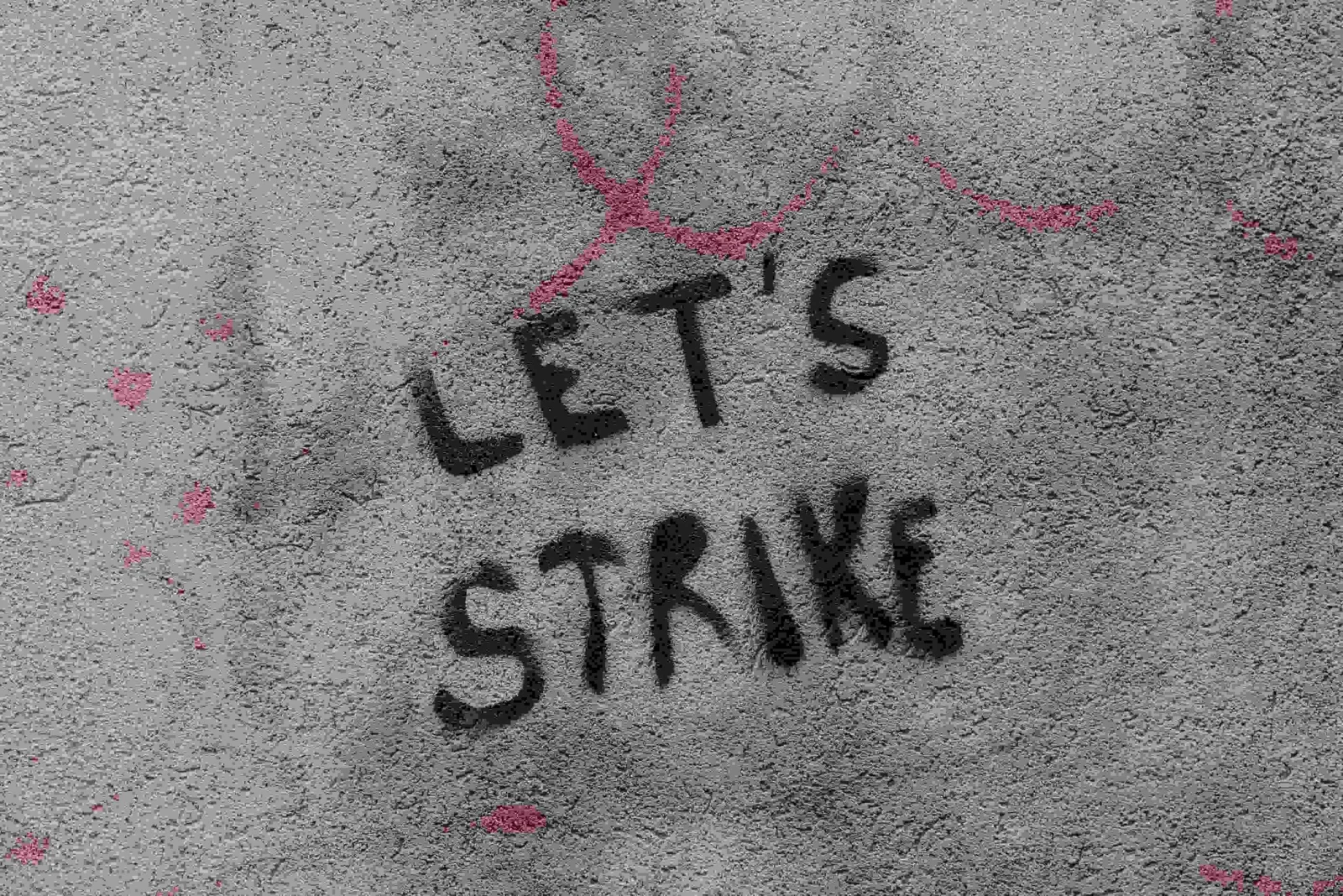 Actors on strike with picket signs, affecting new movie and TV show releases