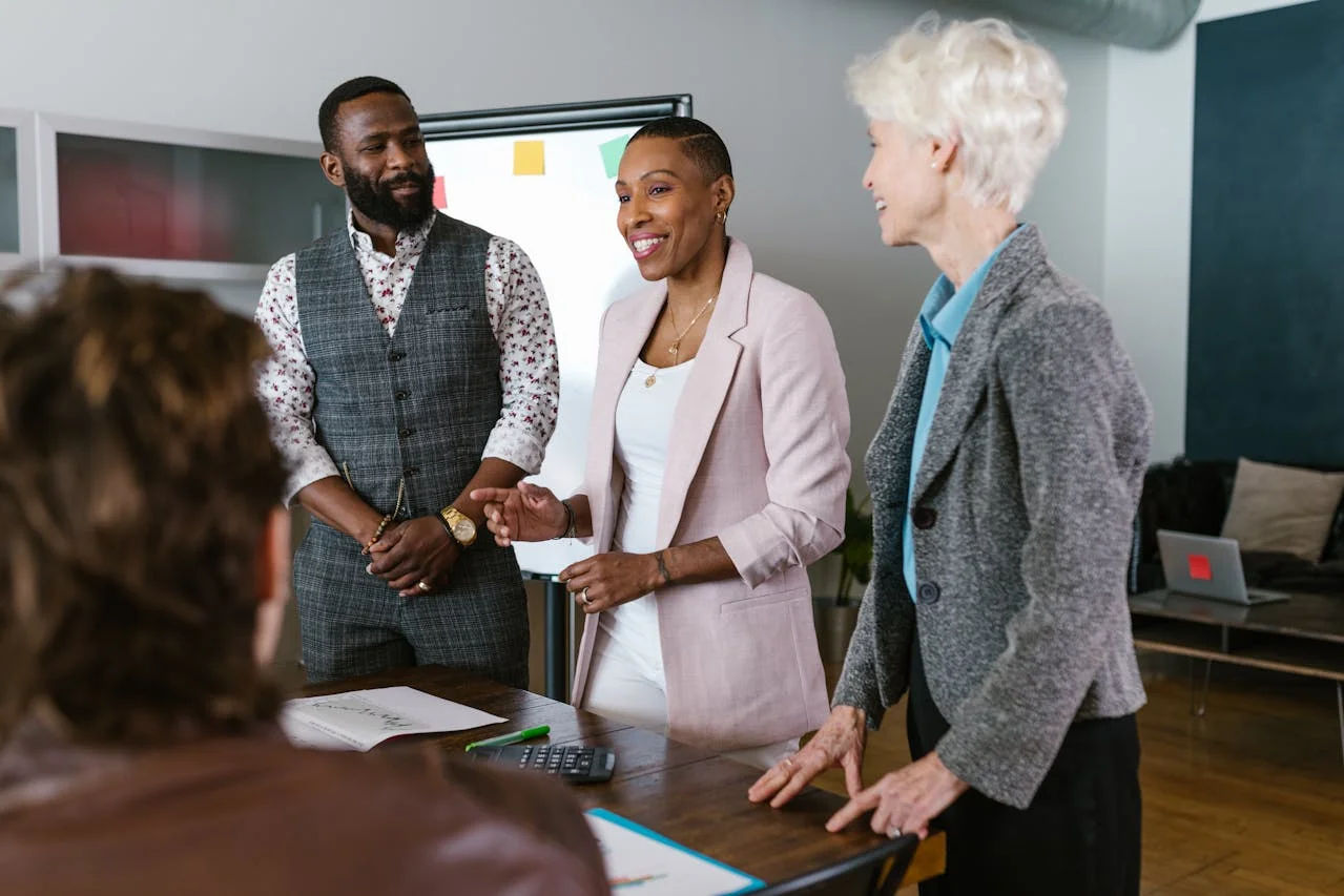 Investors attending a company presentation with charts, graphs, and branded signage