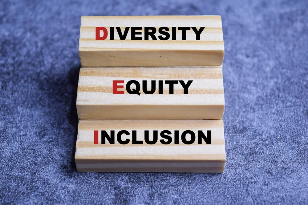 Diverse hands connect jigsaw puzzle pieces, symbolizing inclusive brand messaging and support