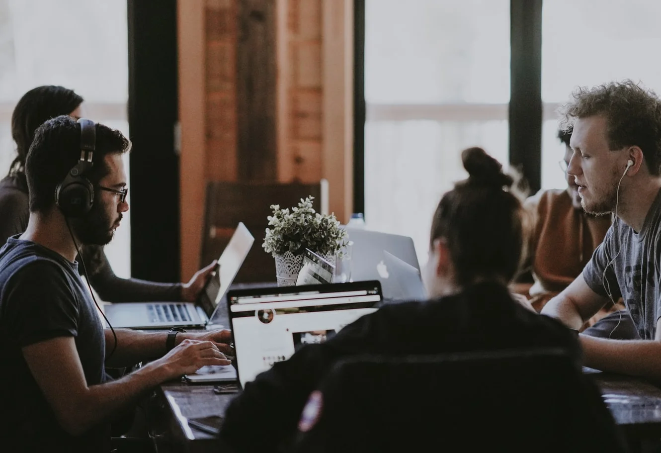 Woman analyzing data on a laptop, understanding digital media marketing metrics