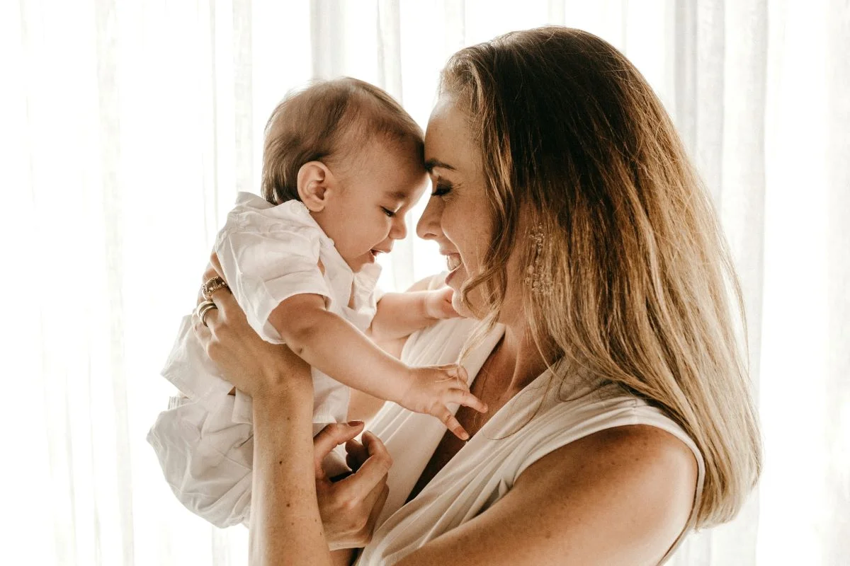 Mom influencer with baby on phone, demonstrating the power of social media marketing