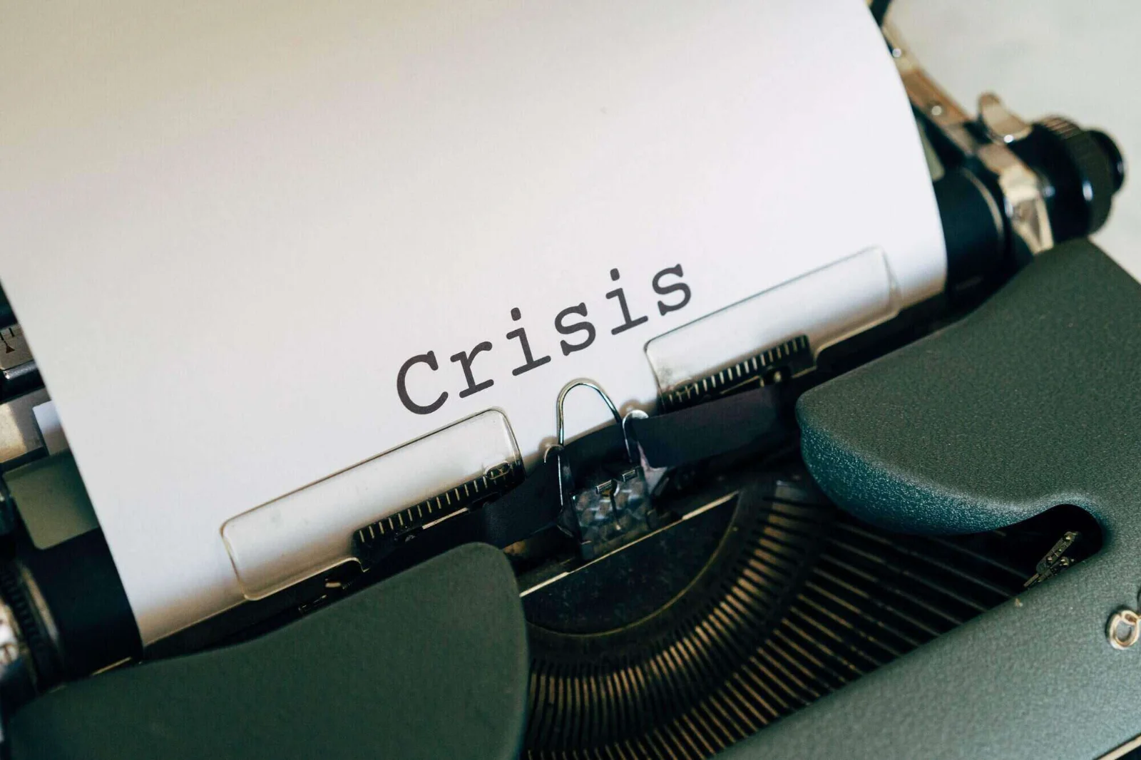 Graphic shows a magnifying glass over social media icons, illustrating digital crisis monitoring