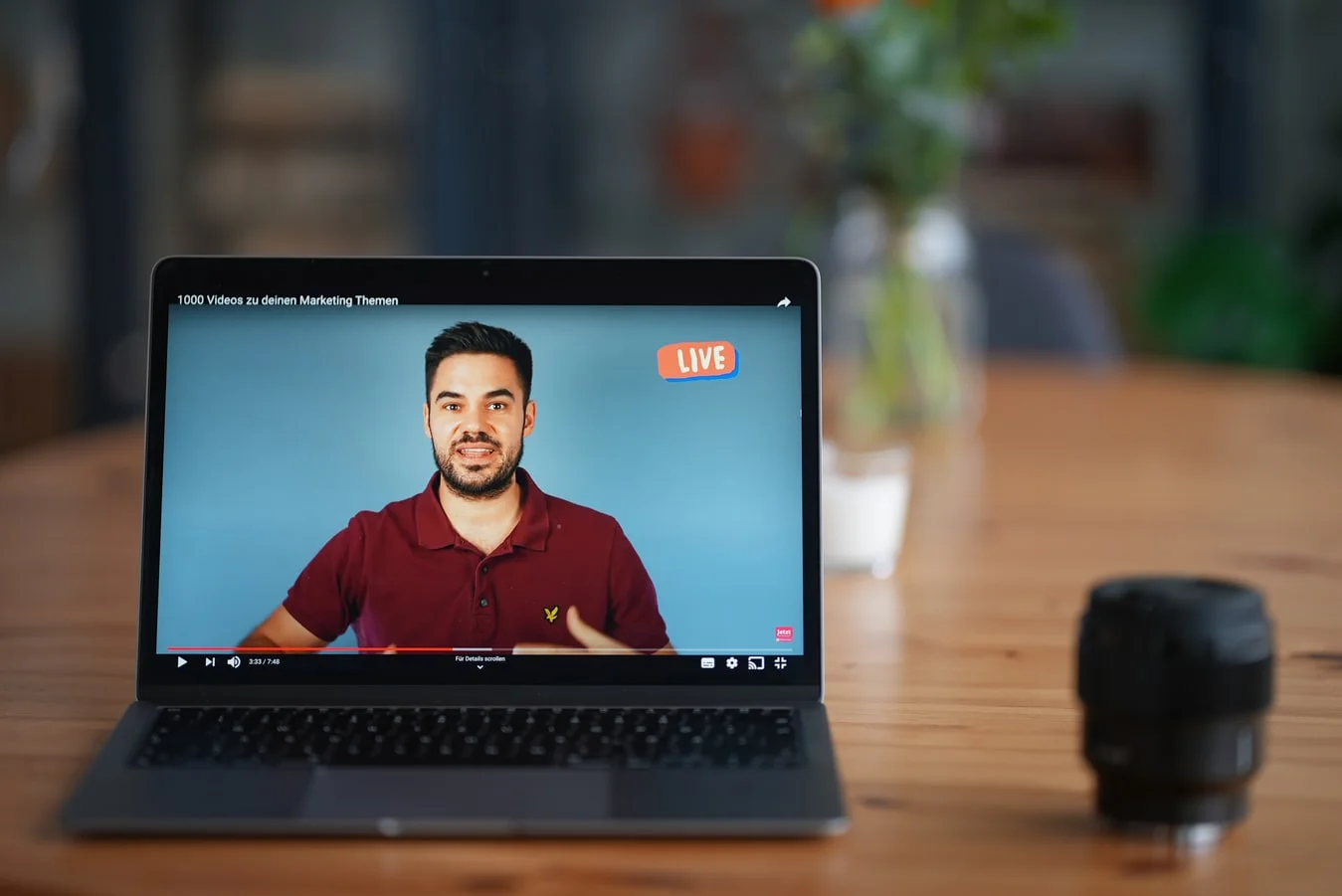 Successful livestreaming: presenter on stage, audience engaged, cameras rolling, bright lights highlighting