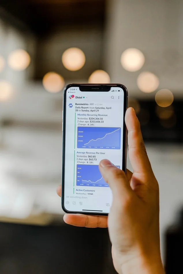 Close up of a person analyzing marketing data on a laptop screen