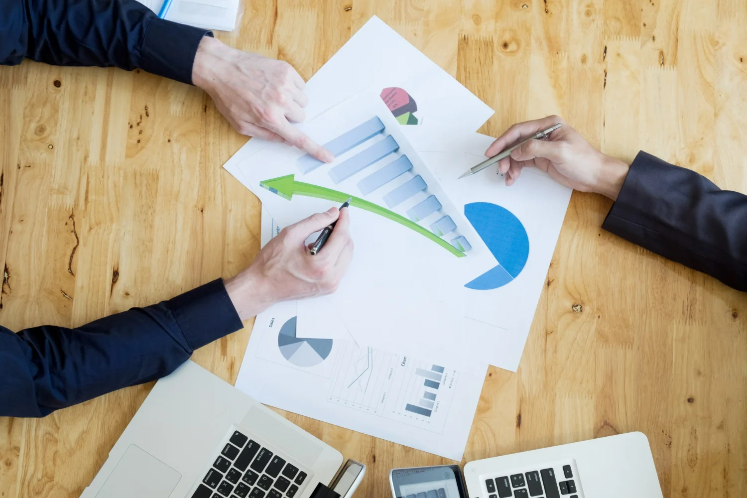 A diverse team collaborates on a laptop, analyzing data to boost app user retention