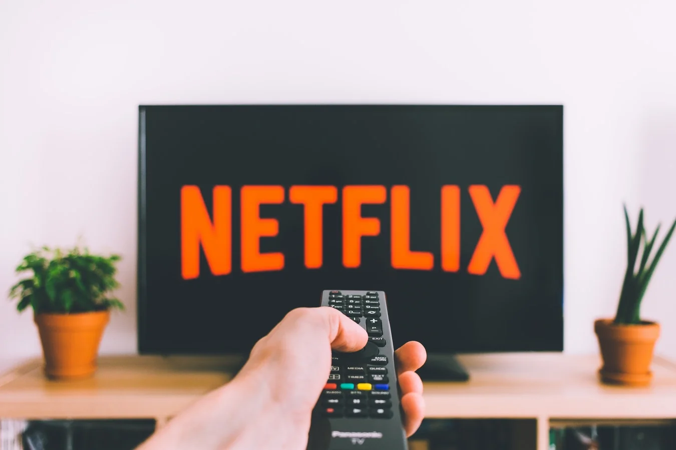 Person looks stressed, covering their face, symbolizing a Netflix public relations crisis
