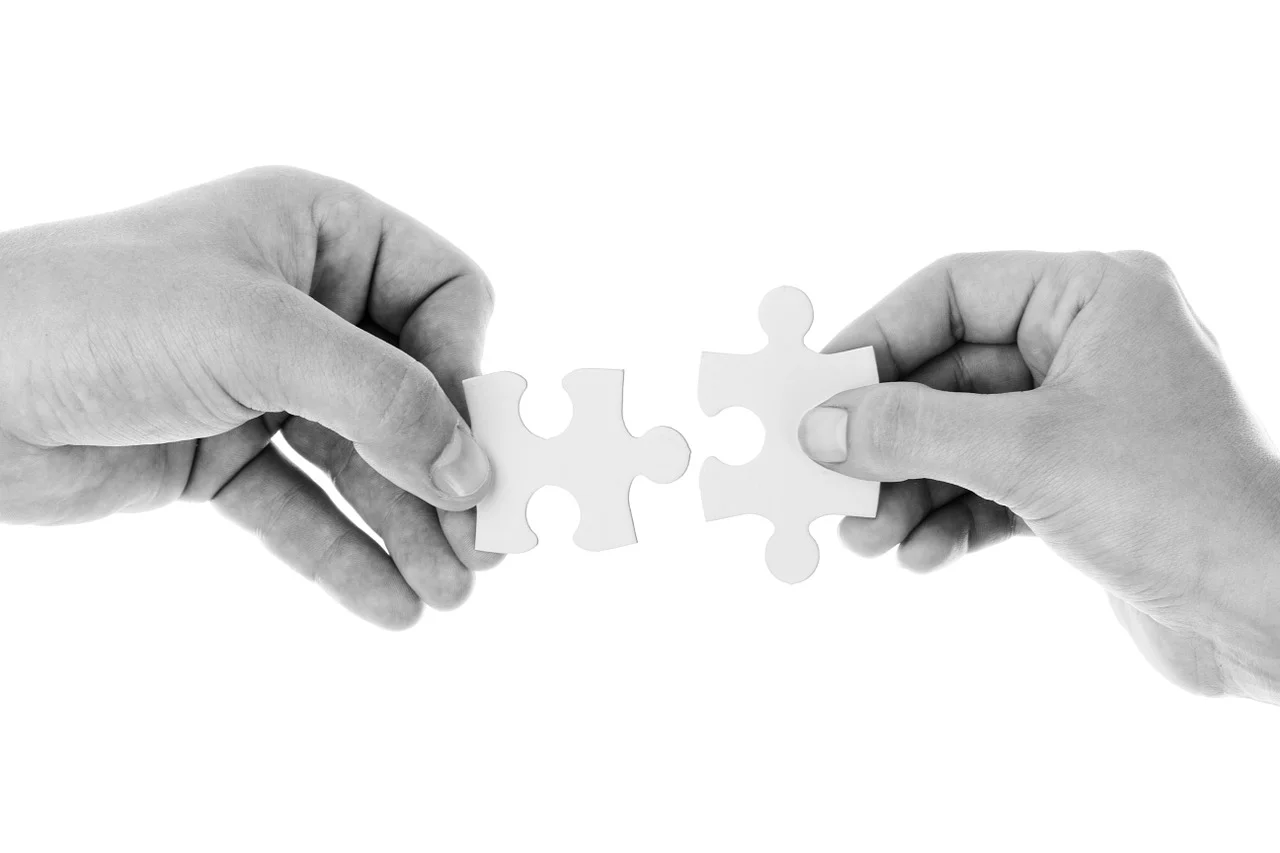 Nonprofit and business leaders shaking hands, symbolizing a beneficial community partnership