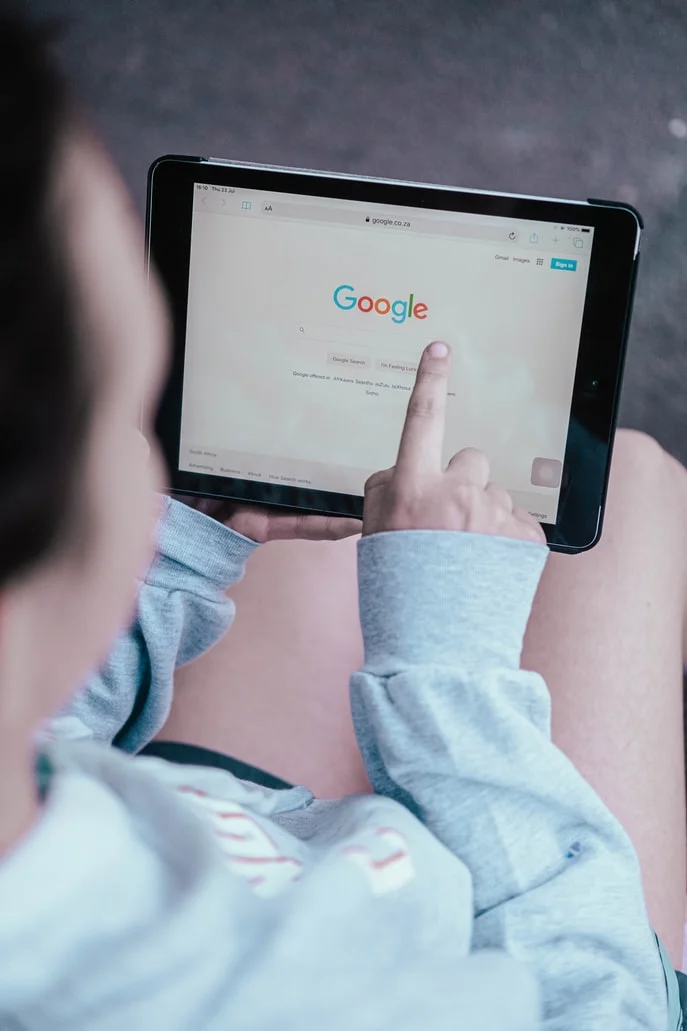 Two magnifying glasses, one blue and one orange, analyzing search results