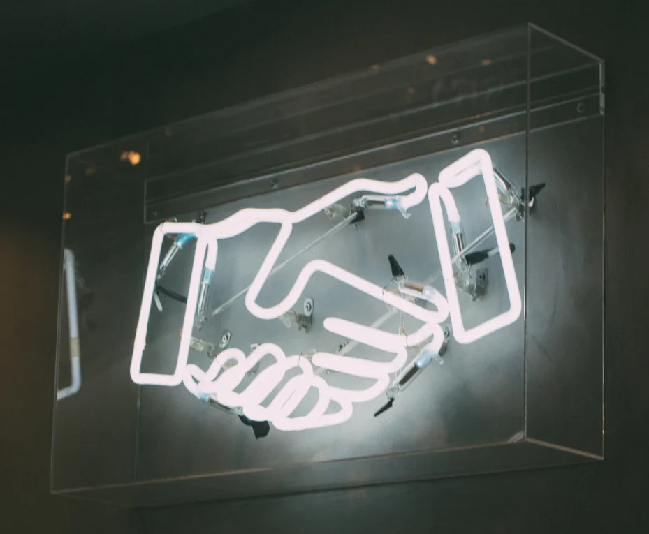 Partnership handshake during the pandemic, showing collaboration and new strategies
