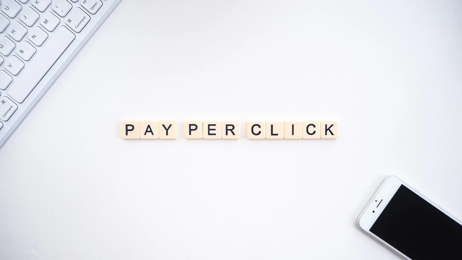 Marketer's finger hovering over a computer mouse, pondering pay-per-click advertising effectiveness