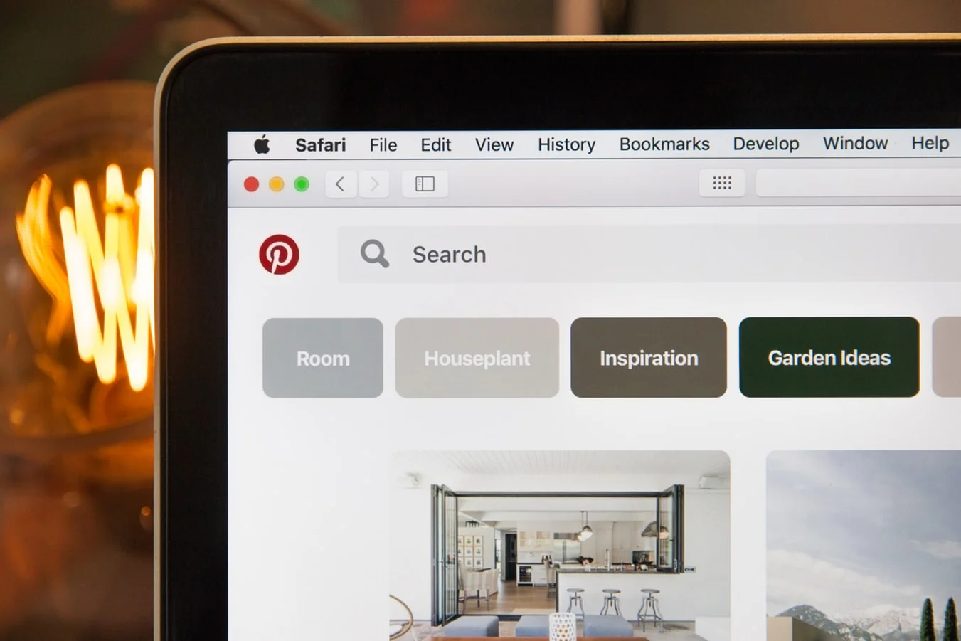 Young woman pinning an image on a laptop, optimizing for Pinterest marketing