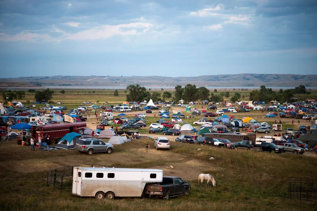 Activists stage a pipeline protest with signs and banners, demonstrating their cause
