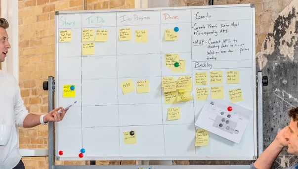 Business leaders huddle urgently in a meeting, reviewing documents during a crisis