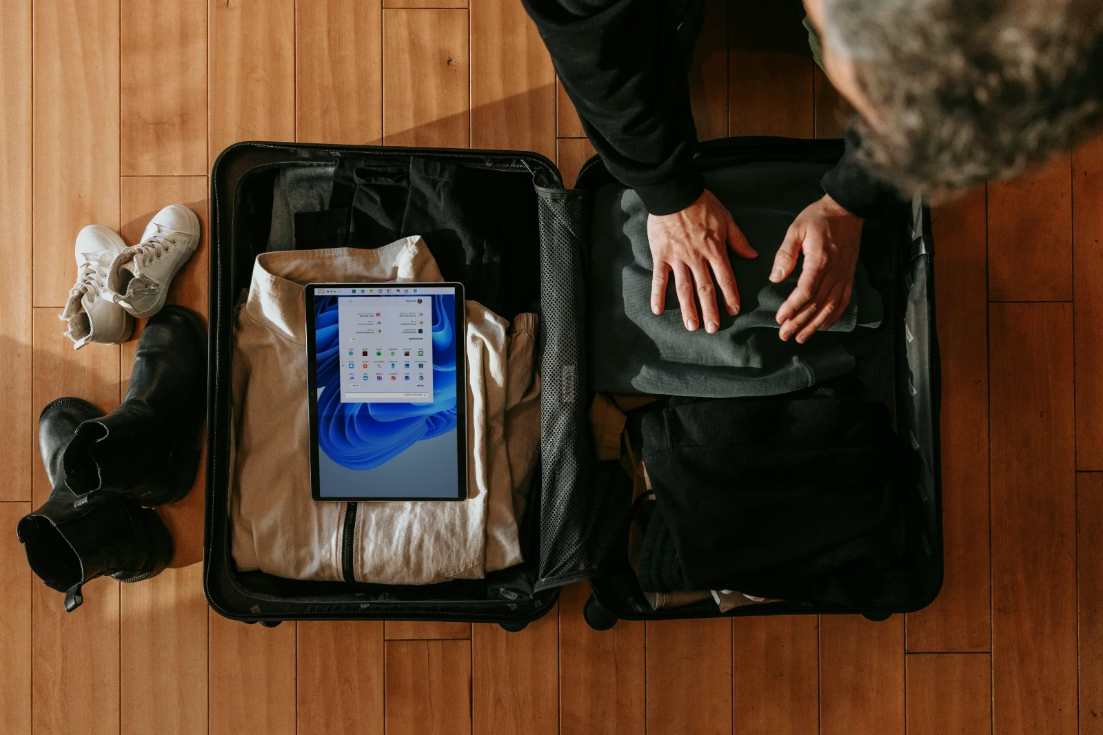 Travel company team brainstorms PR strategies with notes and laptop open