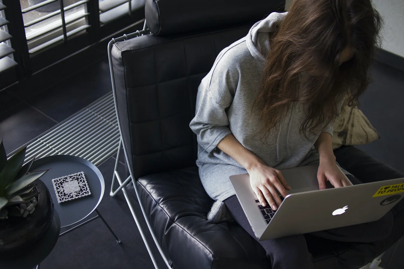Remote worker typing on a laptop, enjoying a flexible and modern work environment
