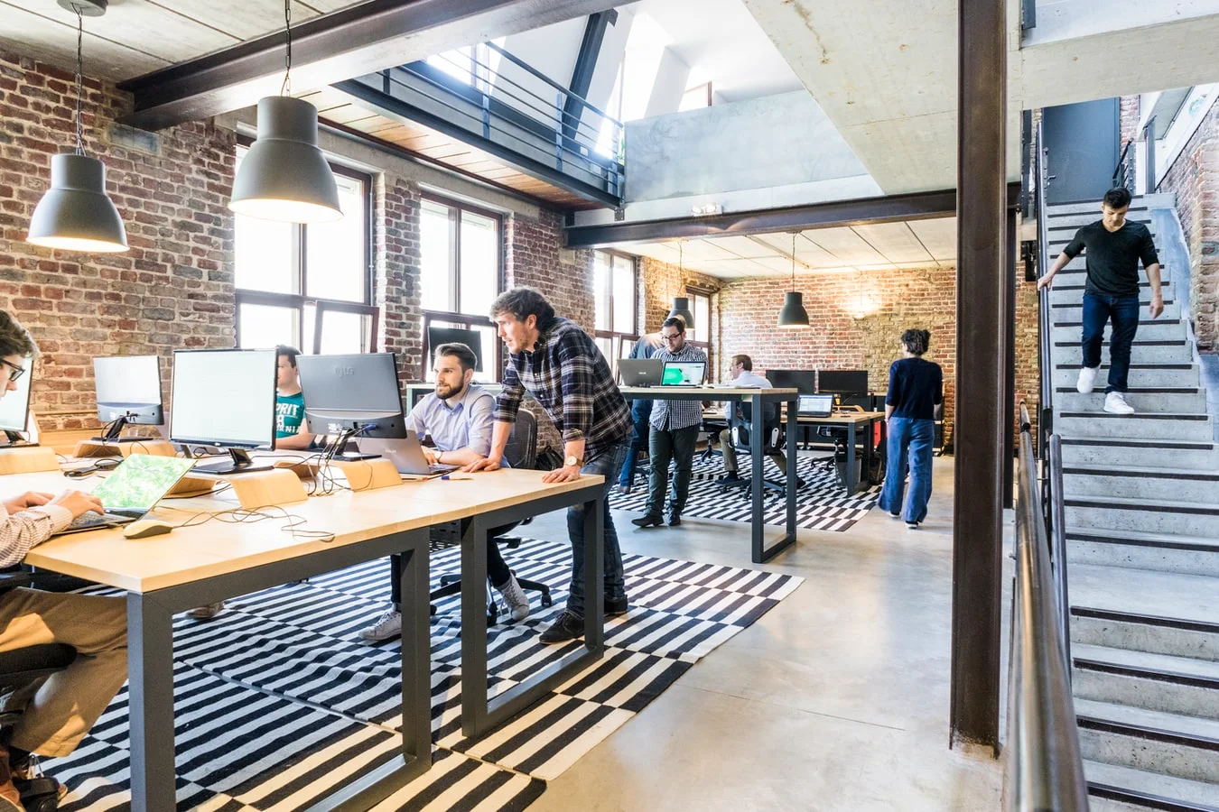 **Featured image:** A group of diverse professionals collaboratively working on laptops and tablets