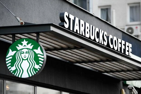 Starbucks employees and customers engage in conversation after a settlement