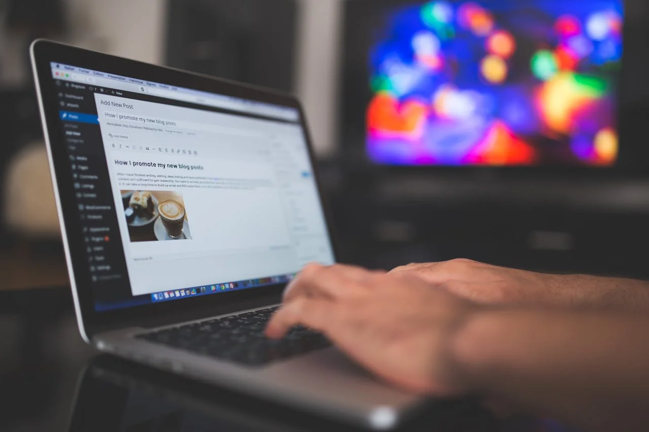 A person brainstorming blog marketing strategies on a laptop with notes and coffee