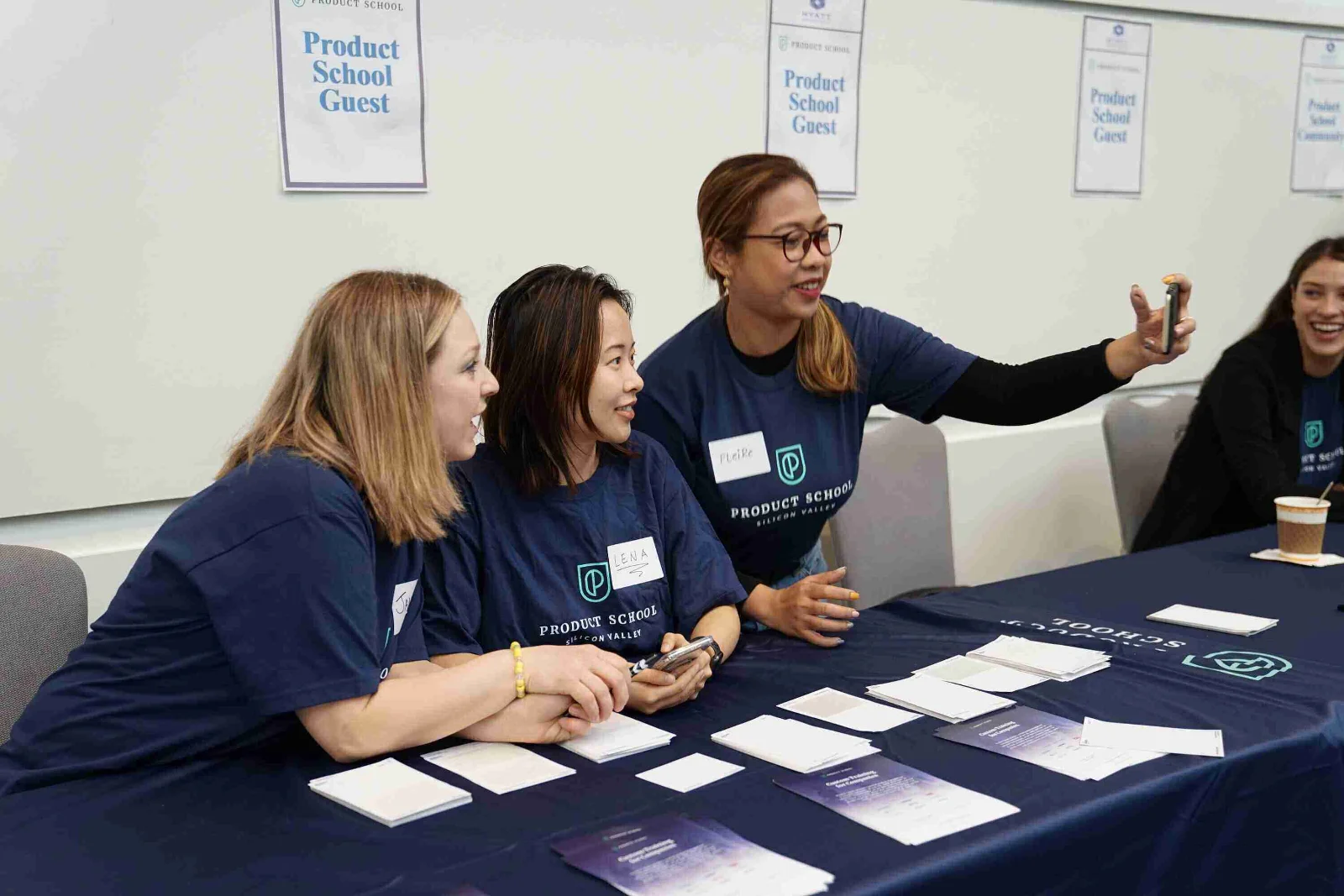 Exhibitor at a busy trade show booth engaging with potential customers