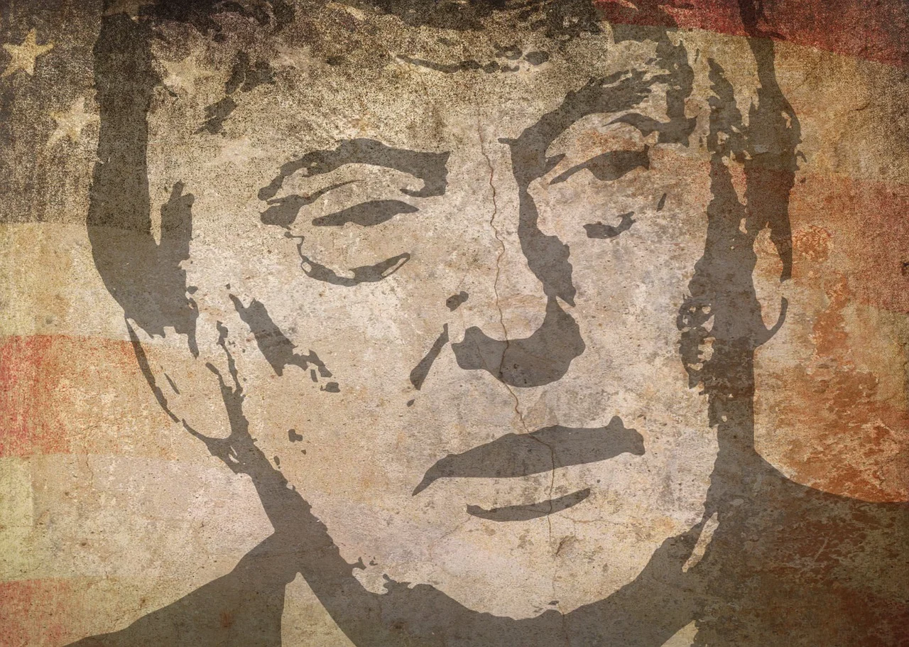 Donald Trump addressing a rally, surrounded by supporters and media cameras