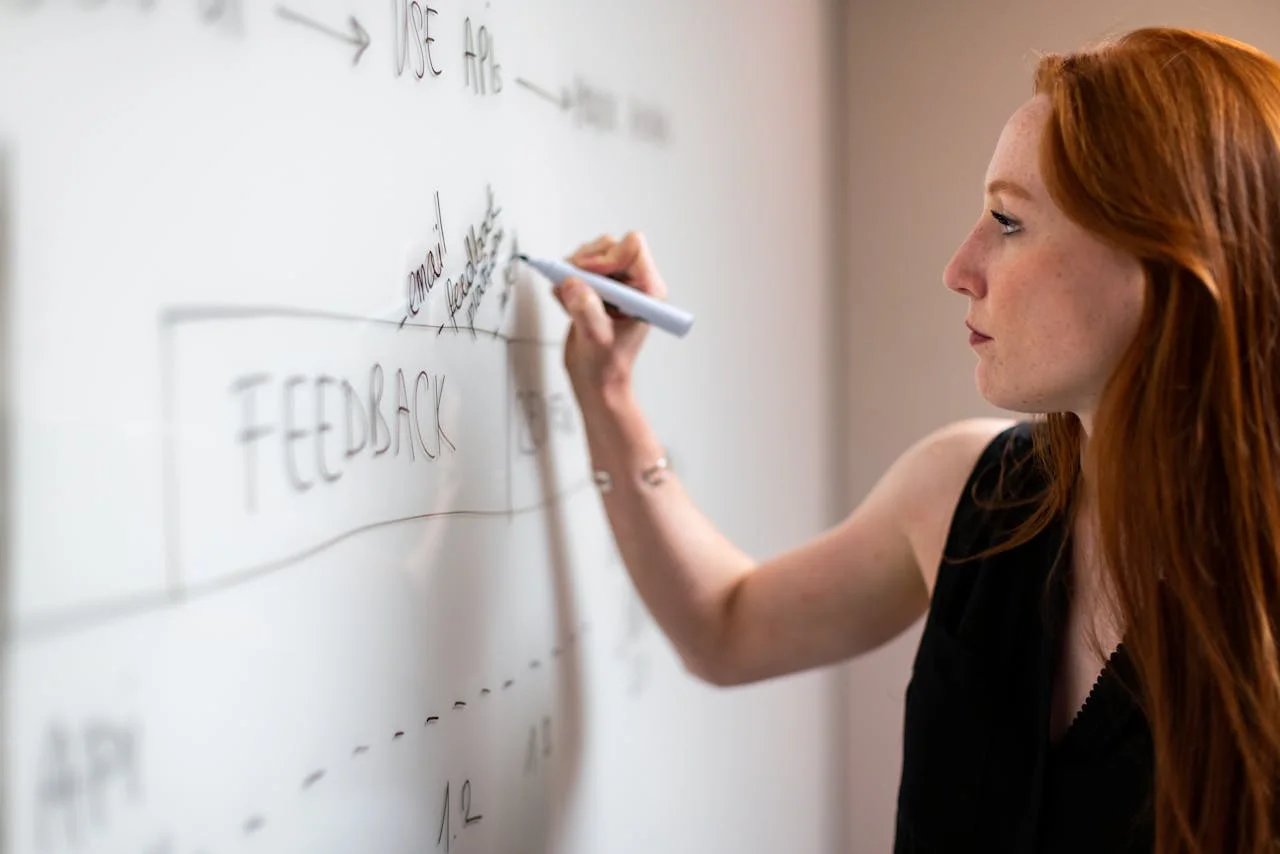 Hand holding megaphone with speech bubbles, representing customer feedback shaping campaigns