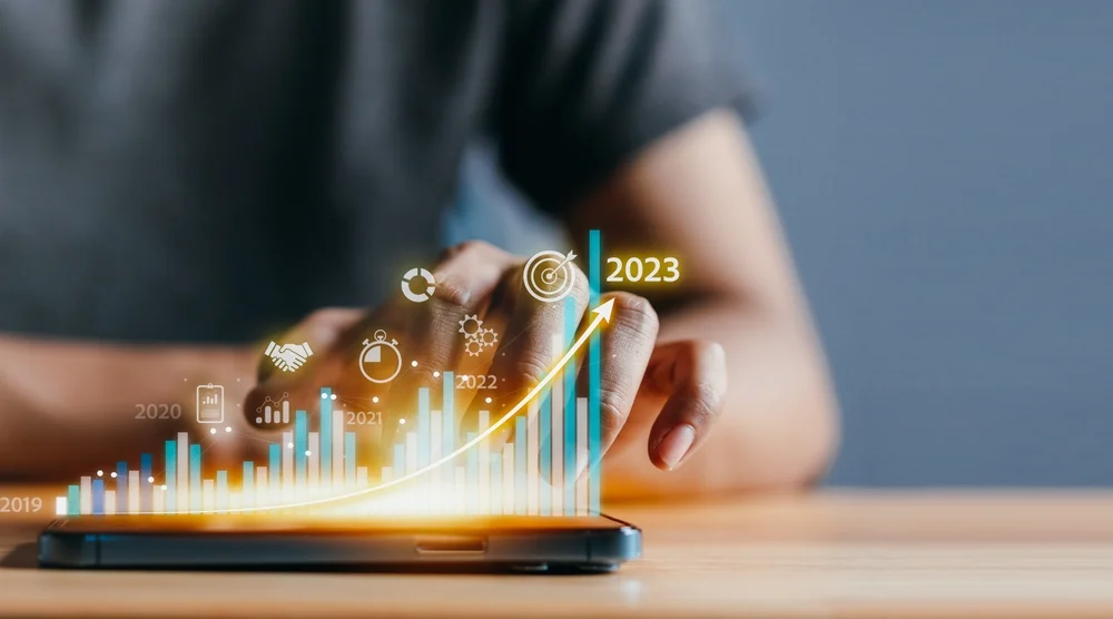 Abstract image of a magnifying glass over charts and graphs, analyzing market data