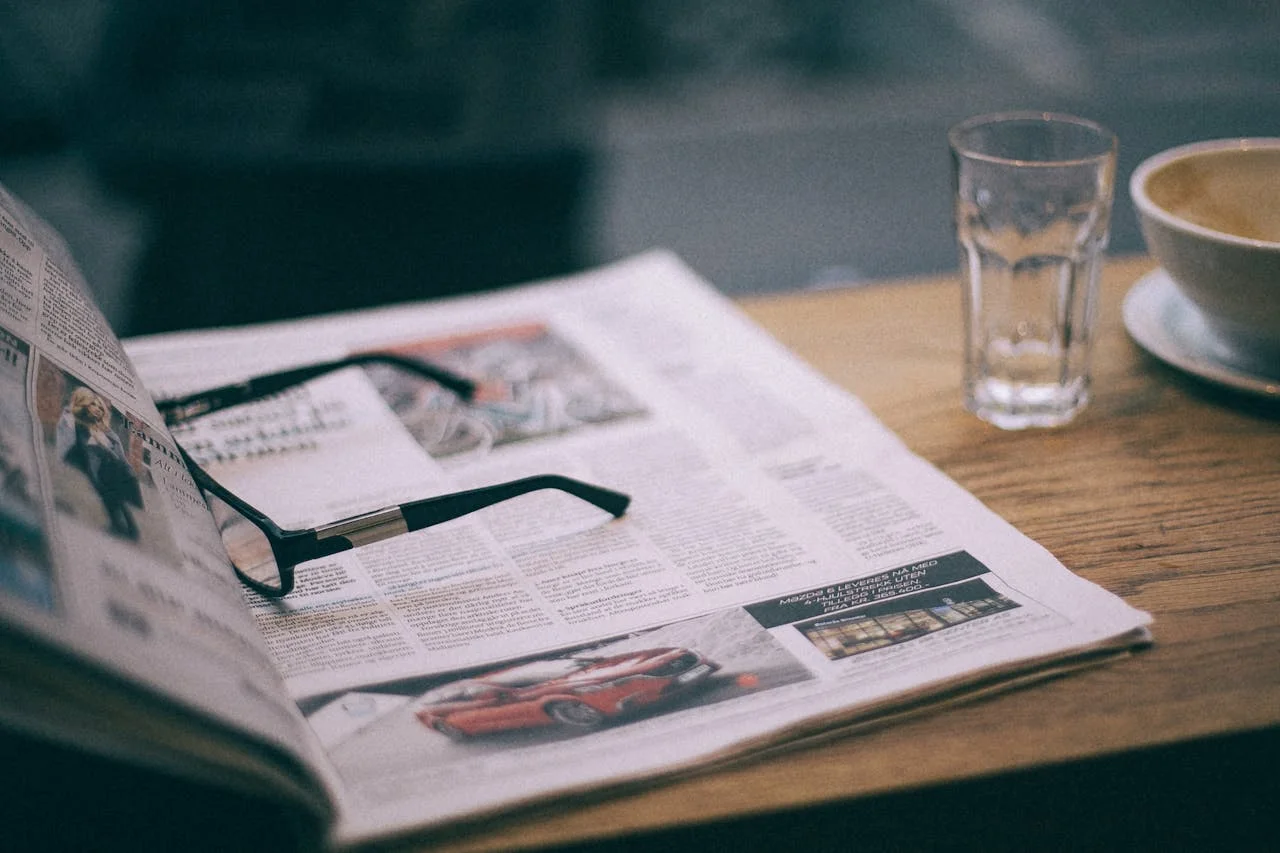 A magnifying glass highlights "Negative Churn" word in a financial newspaper